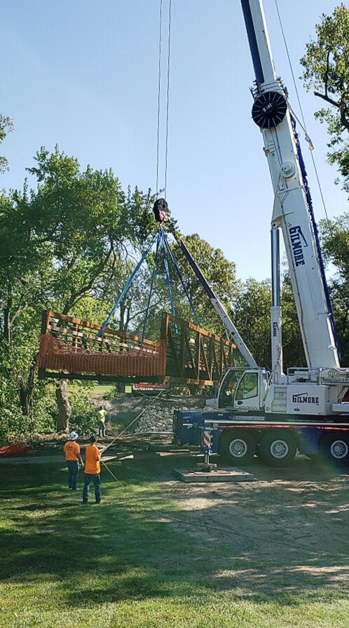Photo of crane lifting a bridge