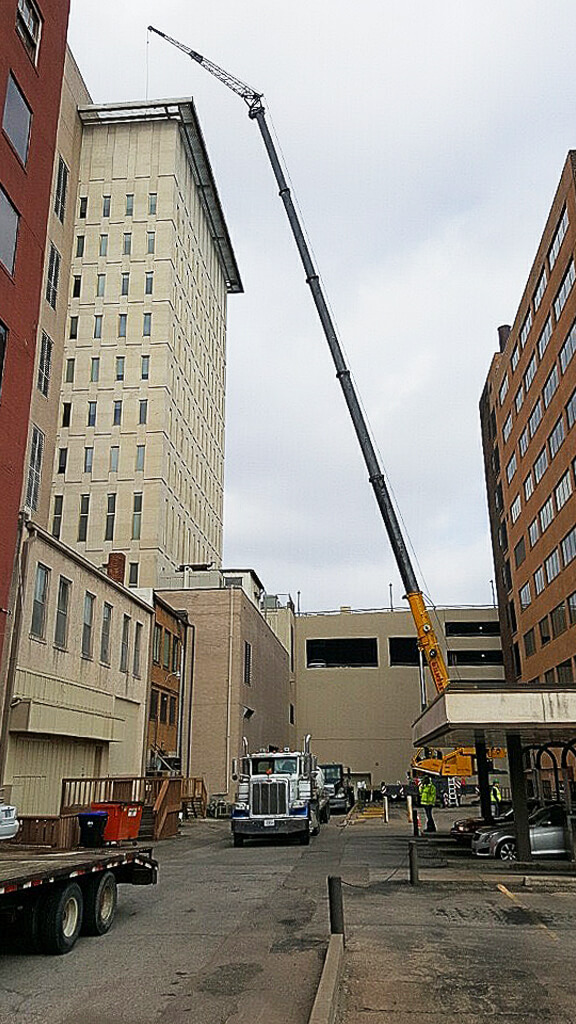 Photo of crane work on tall building