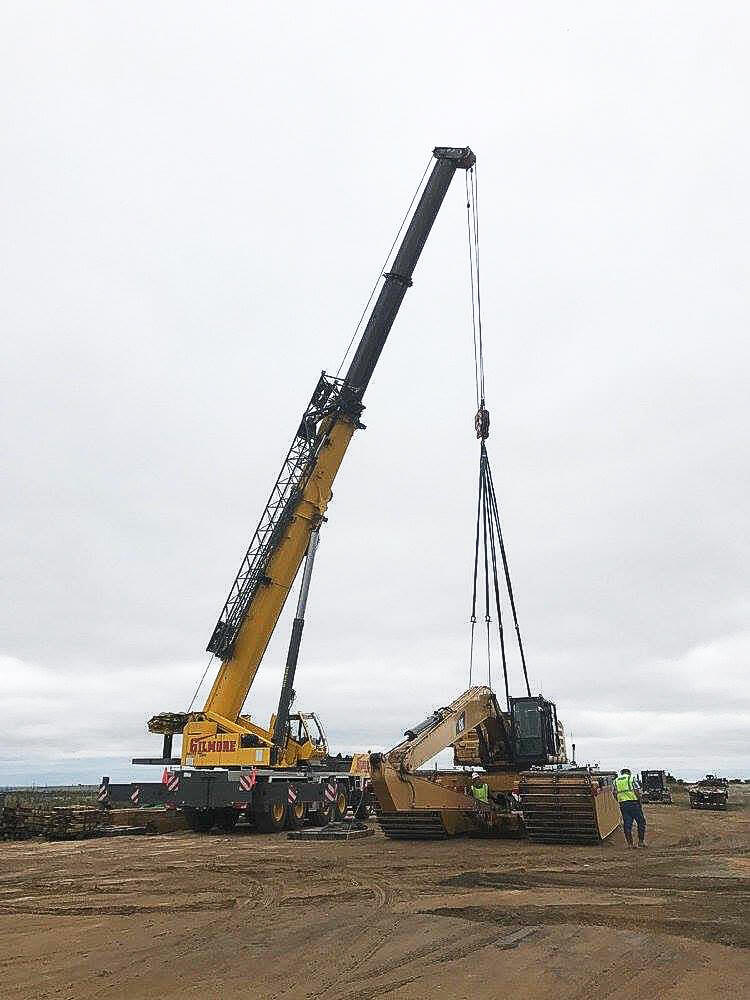 Photo of crane lifting heavy machinery
