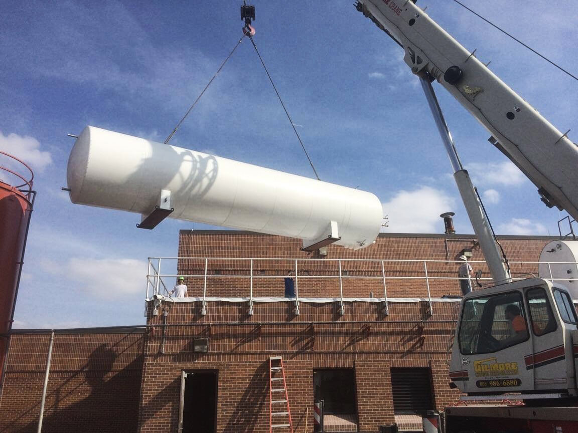 Photo of crane lifting white container